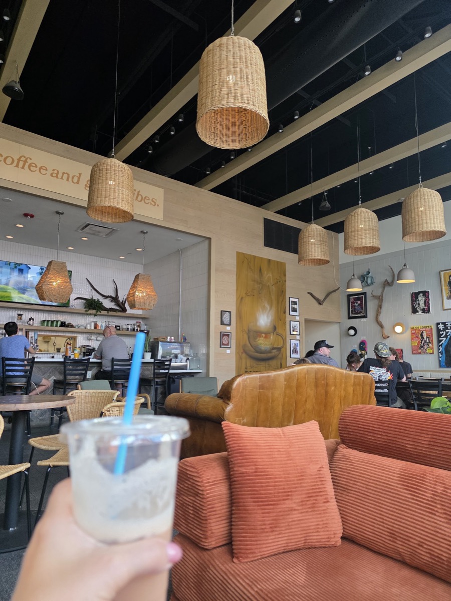 A corduroy couch and armchairs under woven pendant lights in Driftwood’s lounge.